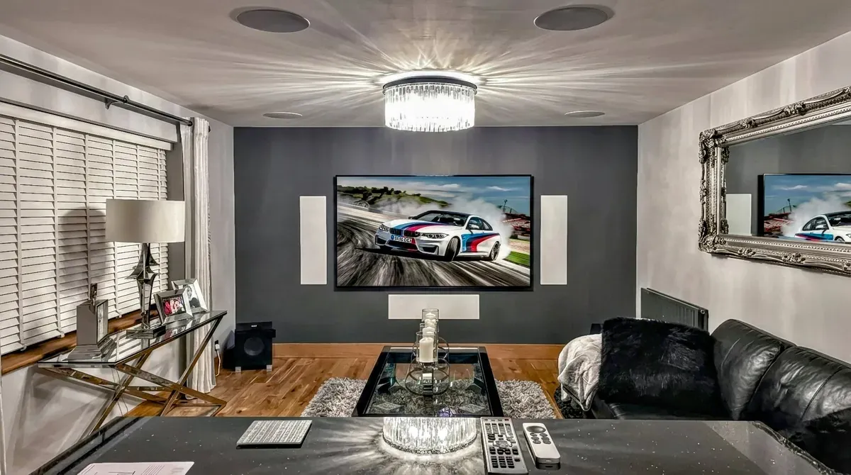 Home cinema installation with wall-mounted TV and in-wall speakers near Witham