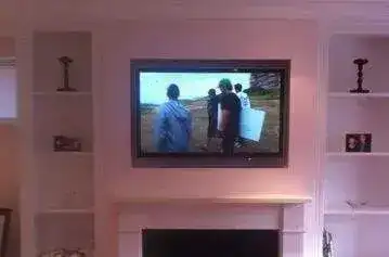 Samsung 55" mounted on brick chimney breast with concealed HDMI and power cables
