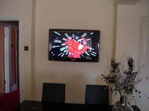 Compact 32" screen fitted in a home office with neat cable routing