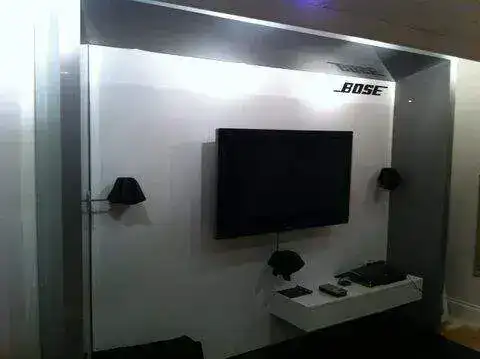 TV mounted above a log burner with heat-safe clearance and hidden cables