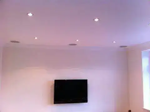 Dual screen setup in a games room with matching brackets and cable management