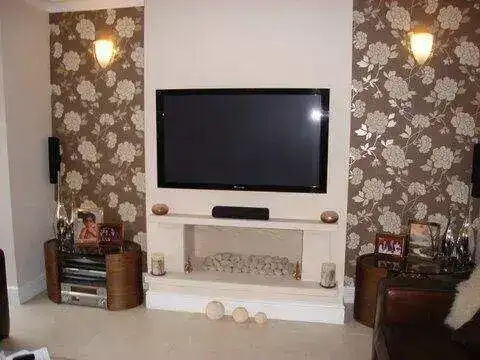 TV bracket with integrated cable cover strip painted to match the wall