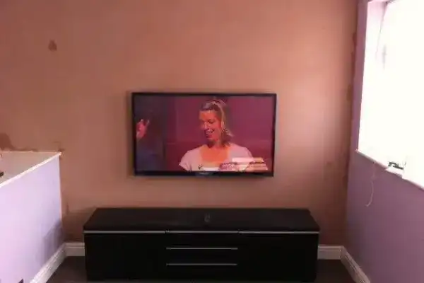 Wall mounted TV with Sky box and Apple TV cables all concealed