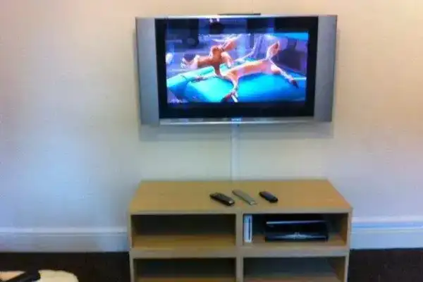 Fixed bracket installation at eye-level height for sofa viewing position