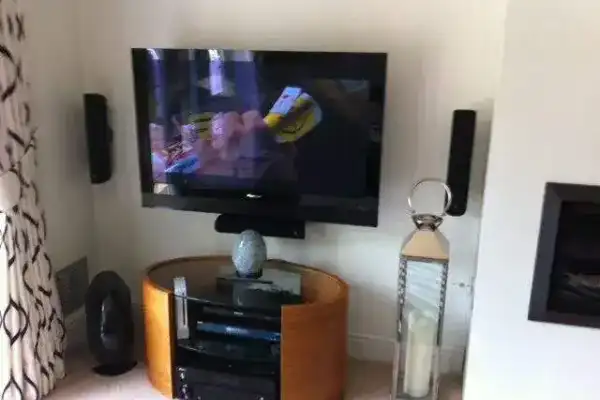 TV mounted on stone wall using masonry fixings with concealed wiring