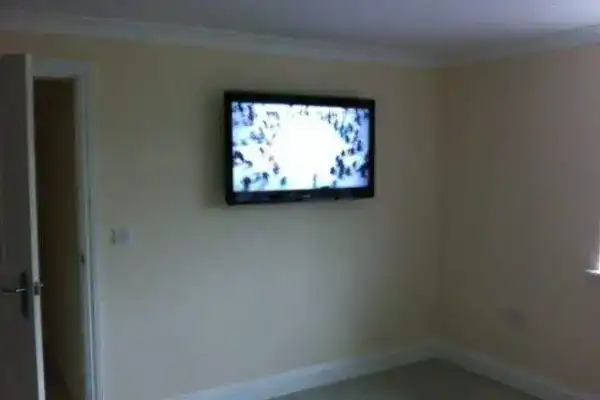 TV wall mount with Sonos soundbar and hidden subwoofer cabling