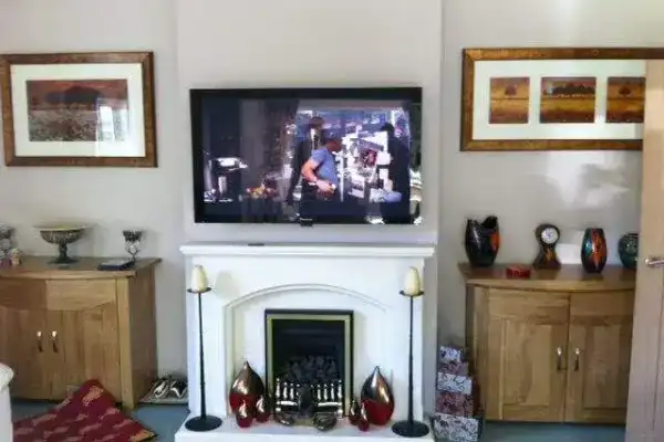 Recessed power and HDMI socket installed behind TV for clean finish