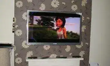 TV bracket fitting on freshly skimmed wall with pre-planned cable route