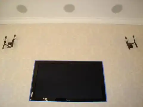 Ceiling speaker installation with wall-mounted TV for home cinema