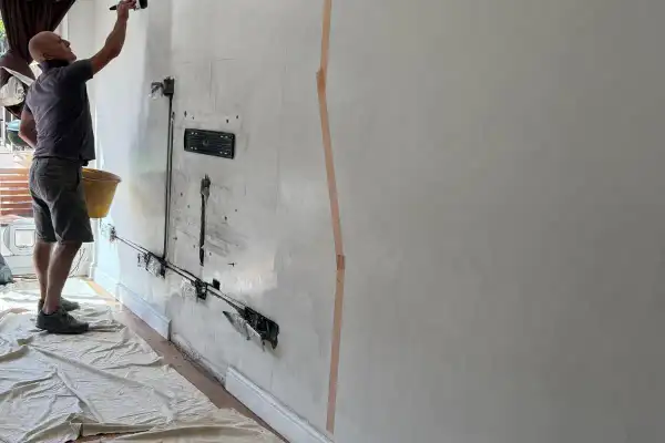 Entertainment wall with TV, soundbar and electric fire in Colchester