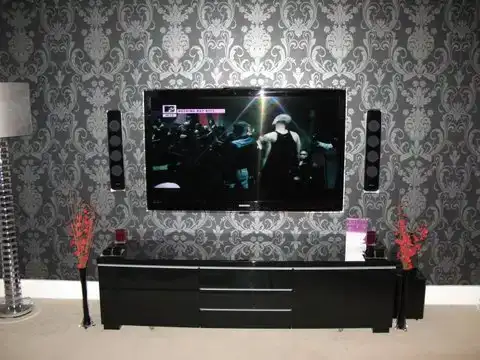 Home cinema with floor-standing speakers and large TV in Colchester