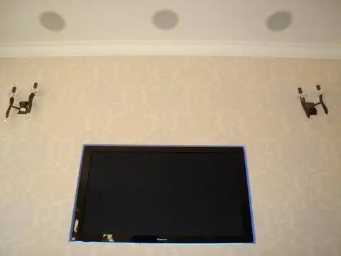 Ceiling speaker installation with wall-mounted TV for home cinema